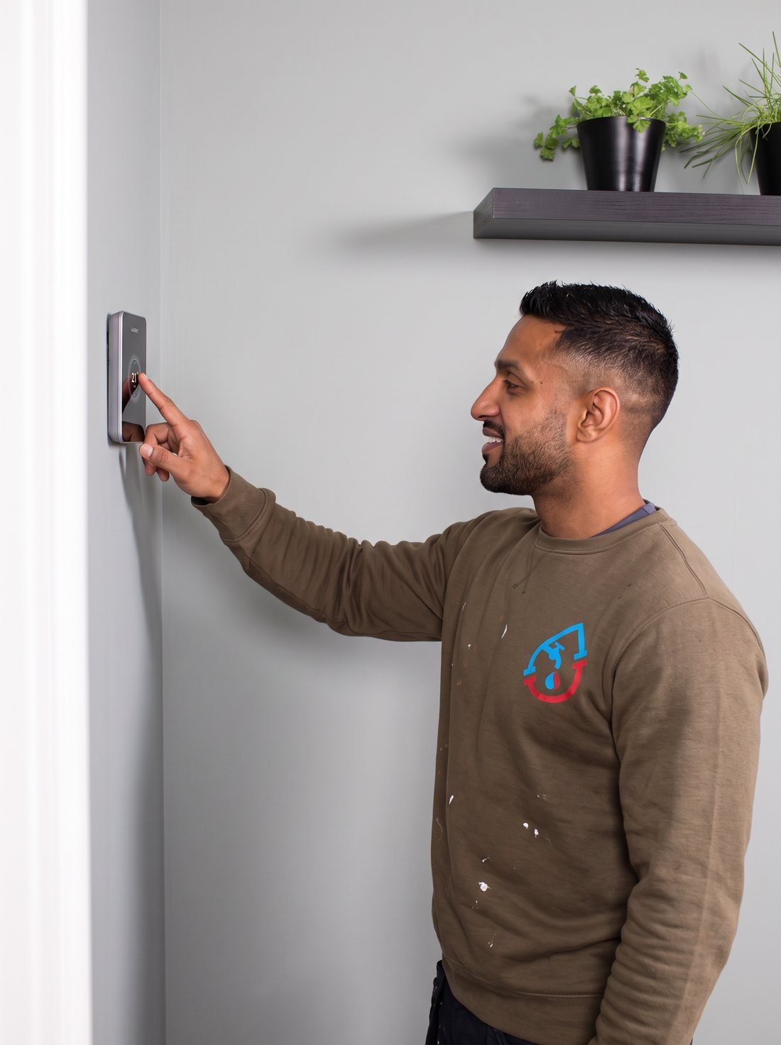 Smart thermostat installed on a hallway wall